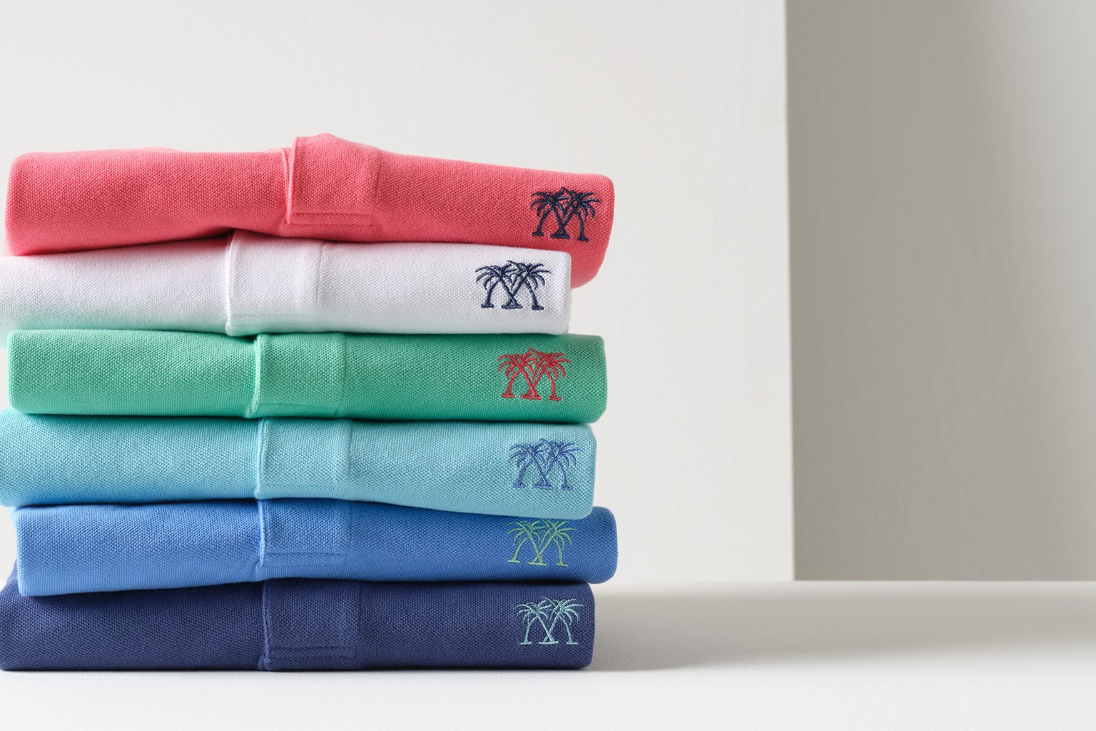 Luxury men's cotton polo shirts in a range of resort-inspired summer colours by Pink House Mustique