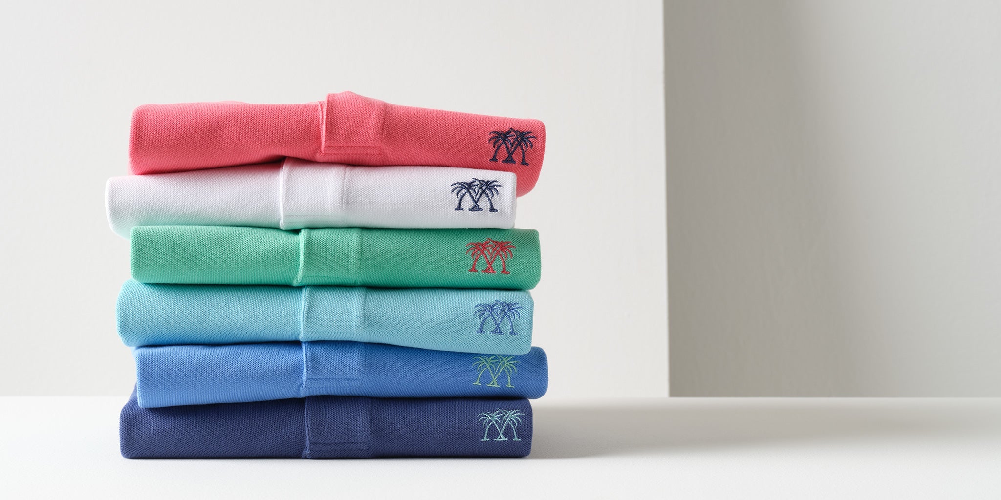 Luxury men's cotton polo shirts in a range of resort-inspired summer colours by Pink House Mustique