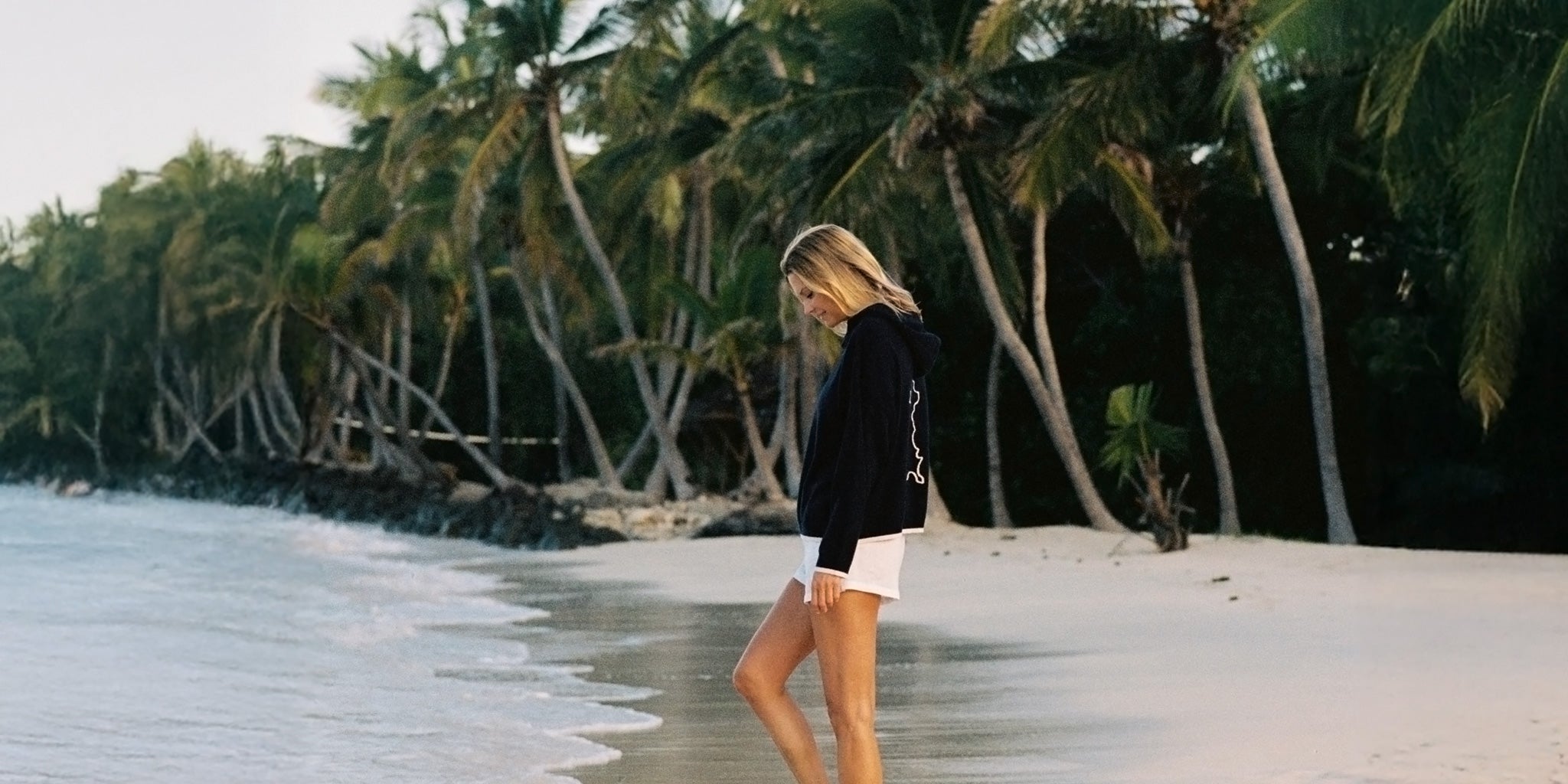 New arrivals at Pink Houseprint silk Amy dress walking through tropical garden on Mustique – new arrivals at Pink House Mustique including luxurious Mongolian cashmere hoodies in collaboration with Malin Darlin London