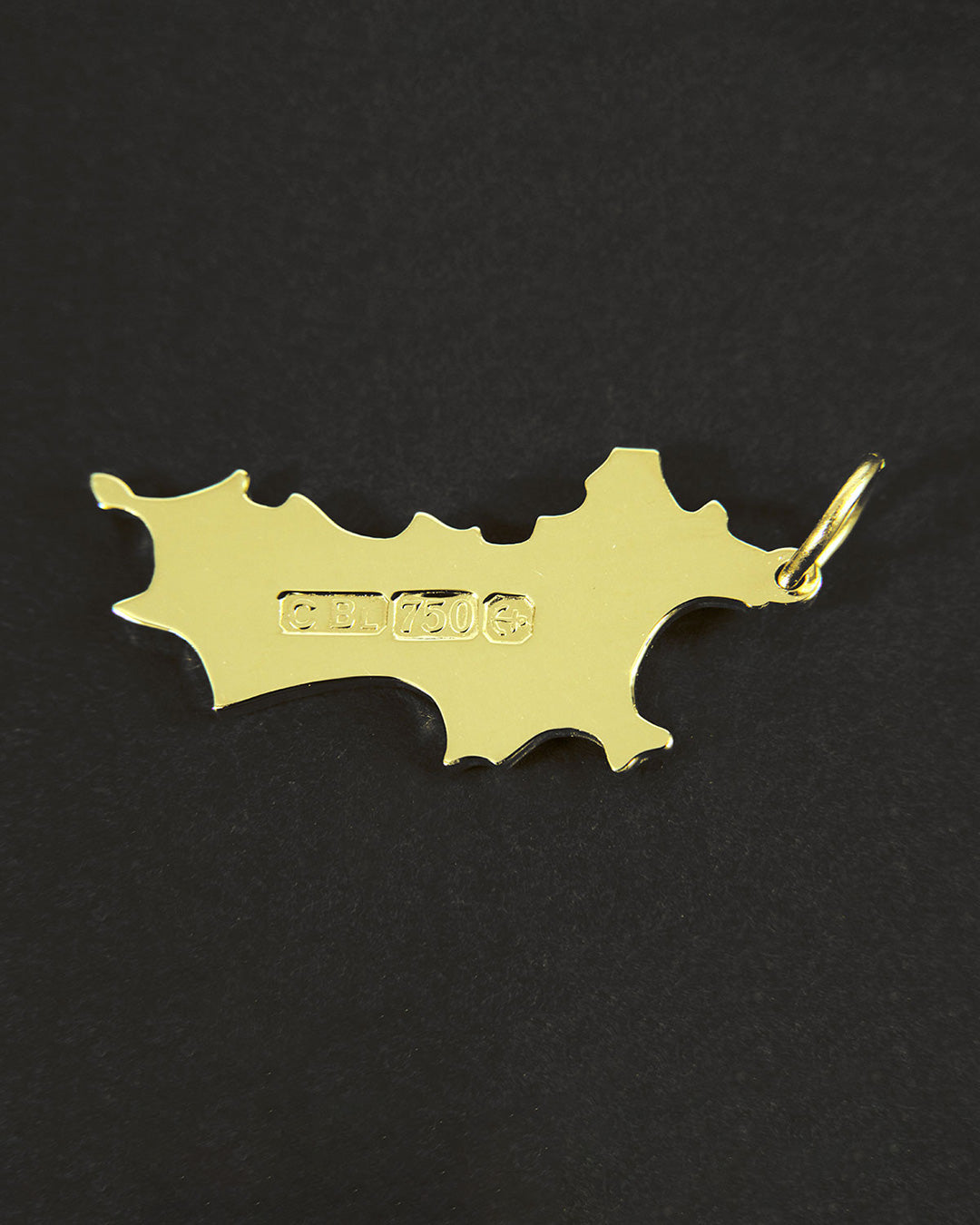 Back of 18k gold Mustique island pendant showing 750 hallmark luxury island necklace made in England