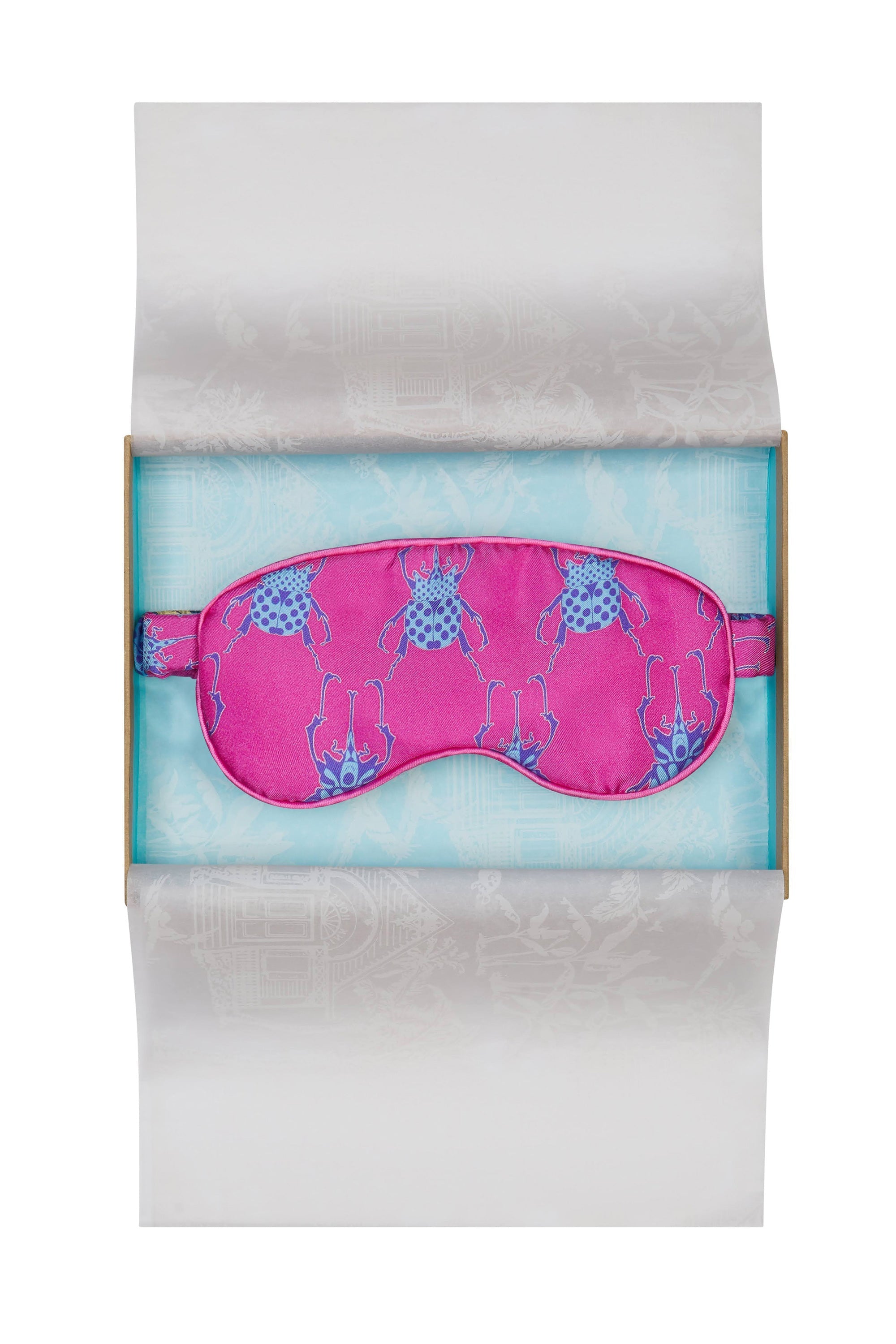 Luxury silk eye mask in bright pink and blue Beetle print. Limited edition sleepwear accessories by Lotty B Mustique. Handmade in England