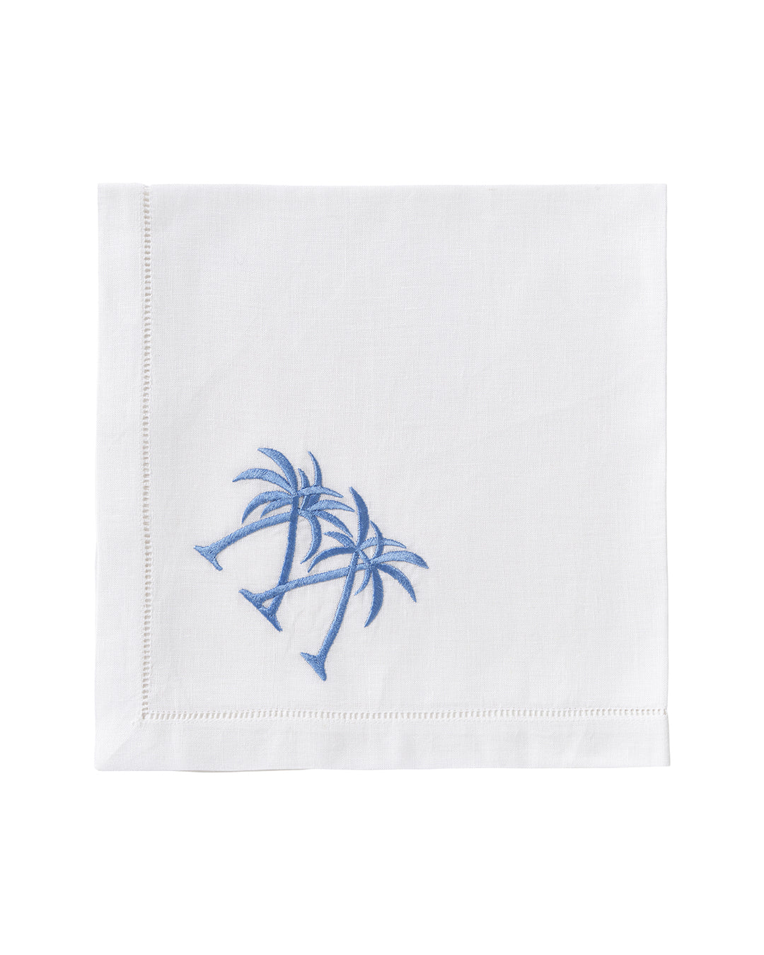 White linen napkin embroidered with blue palm trees – signature Pink House Mustique coastal napkin design