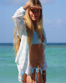 Milla in Monkey & Palms print Anastasia Shirt by Pink House Linen – lightweight linen shirt in pale blue and green tones, ideal for coastal style and summer beachwear.