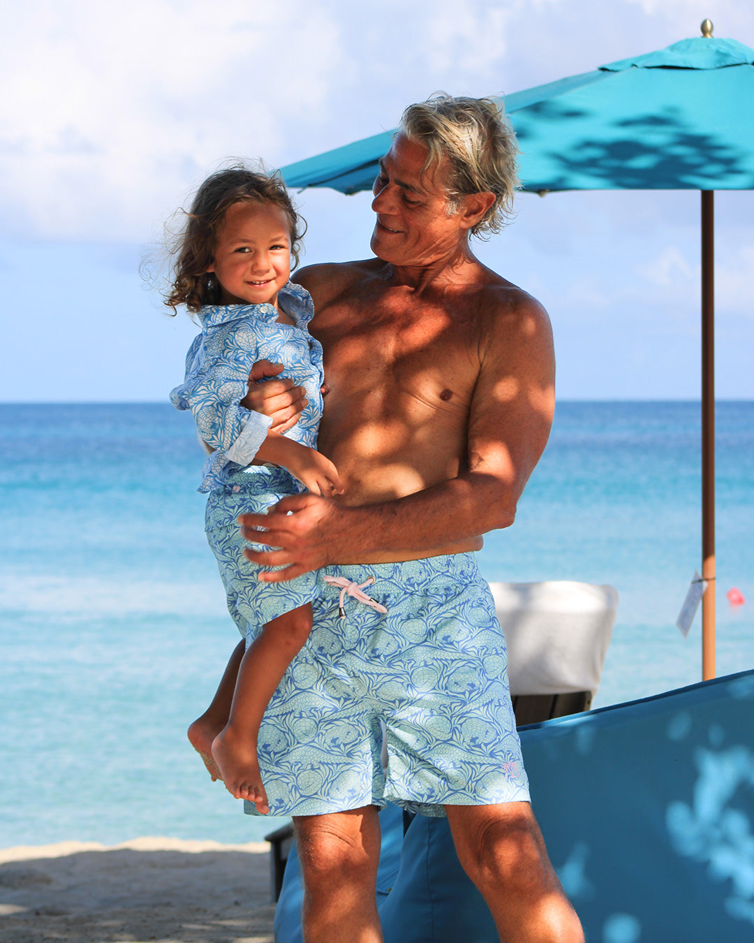 older man and child in matching holiday shorts