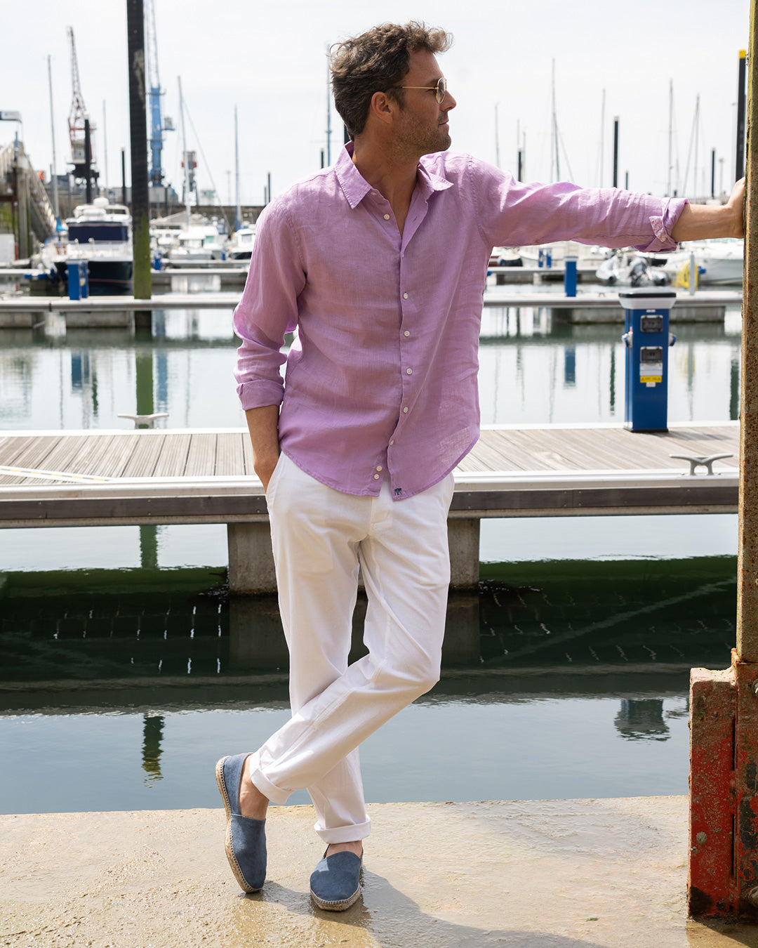 Classic yacht holiday clothing white linen pants worn with lilac linen shirt. Designer linen resortwear by Pink House