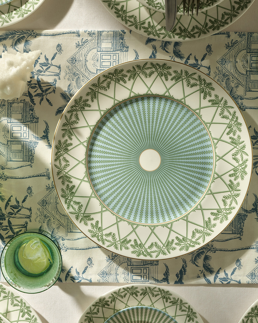 Fine bone china charger plate in Palms Sage Green used as a decorative serving plate, handmade by Pink House Mustique.