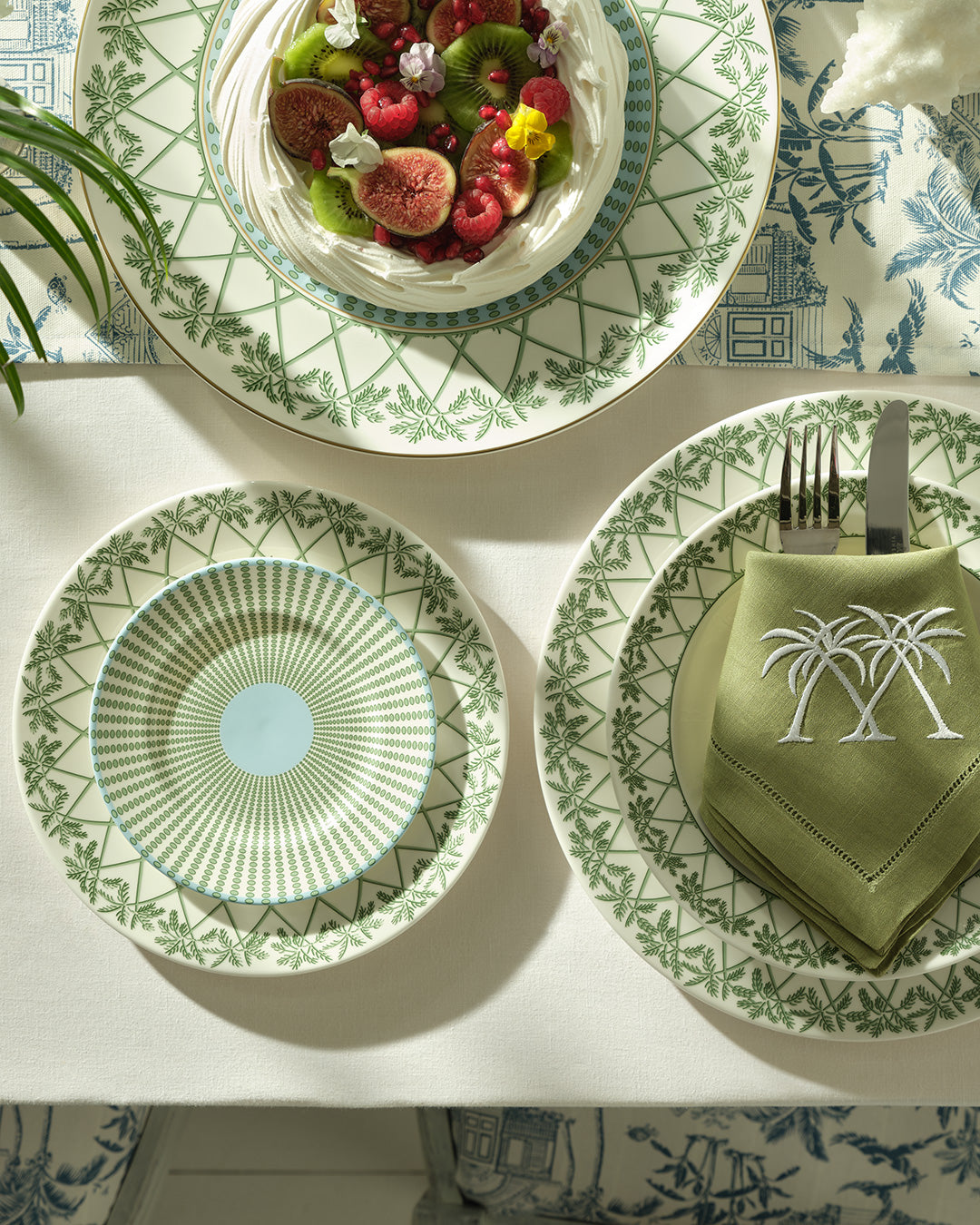Chic fine bone china charger and side plates layered on salad plate in Palms Sage Green, luxury island tableware design.