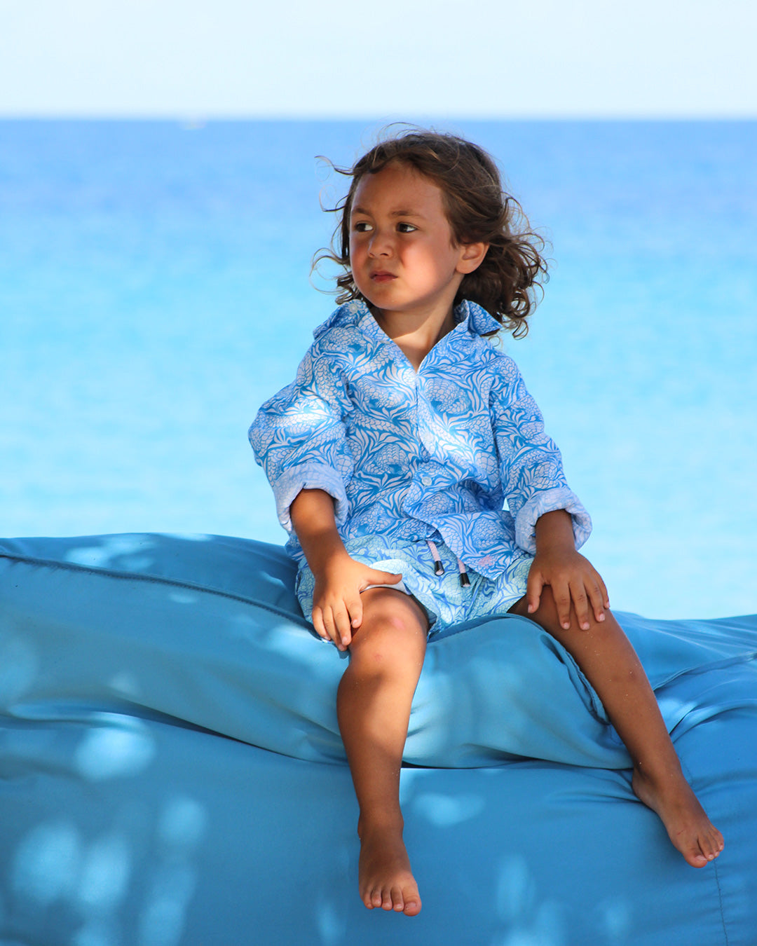 young boy in matching linene shirt and holiday shorts