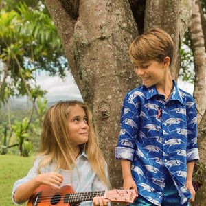 Kids hanging out in fun linen holiday shirts with egret print by Lotty B Mustique