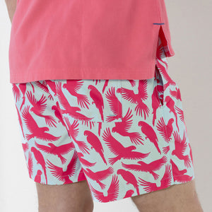 Men's beach shorts in turquoise blue and coral red Parrot print by designer Lotty B