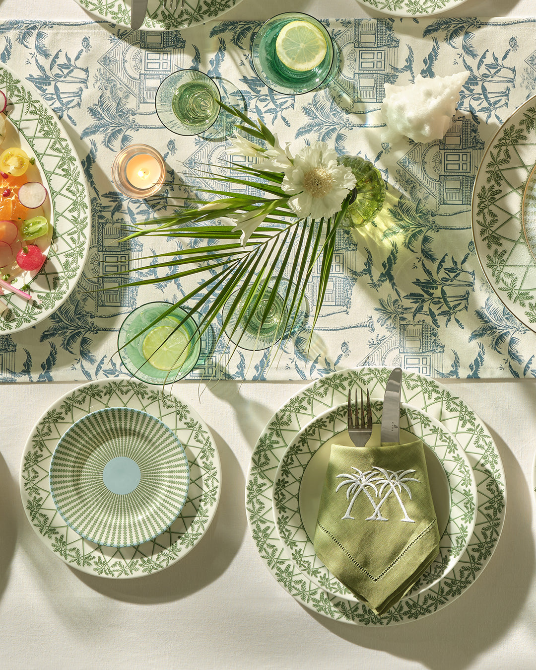 Elegant fine bone china place setting with rimmed bowl on dinner plate and side plate stacked on salad plate in Palms Sage Green.