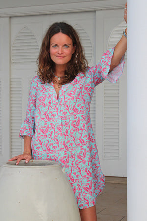 Holiday style women's linen dress in turquoise blue and coral red Parrot print by designer Lotty B