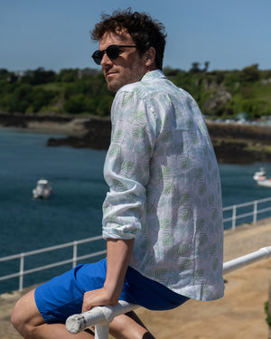 Vacation style mens linen shirt in Monkey & Palm pale blue & green print by designer Lotty B