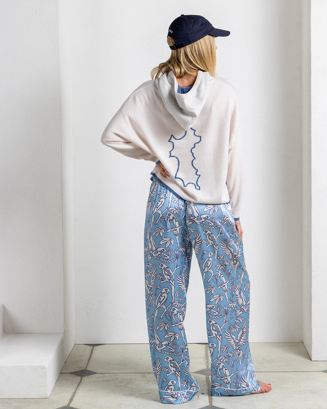Silk pajama trousers in Parrot Blue print styled with cashmere hoodie – relaxed luxury loungewear by Lotty B