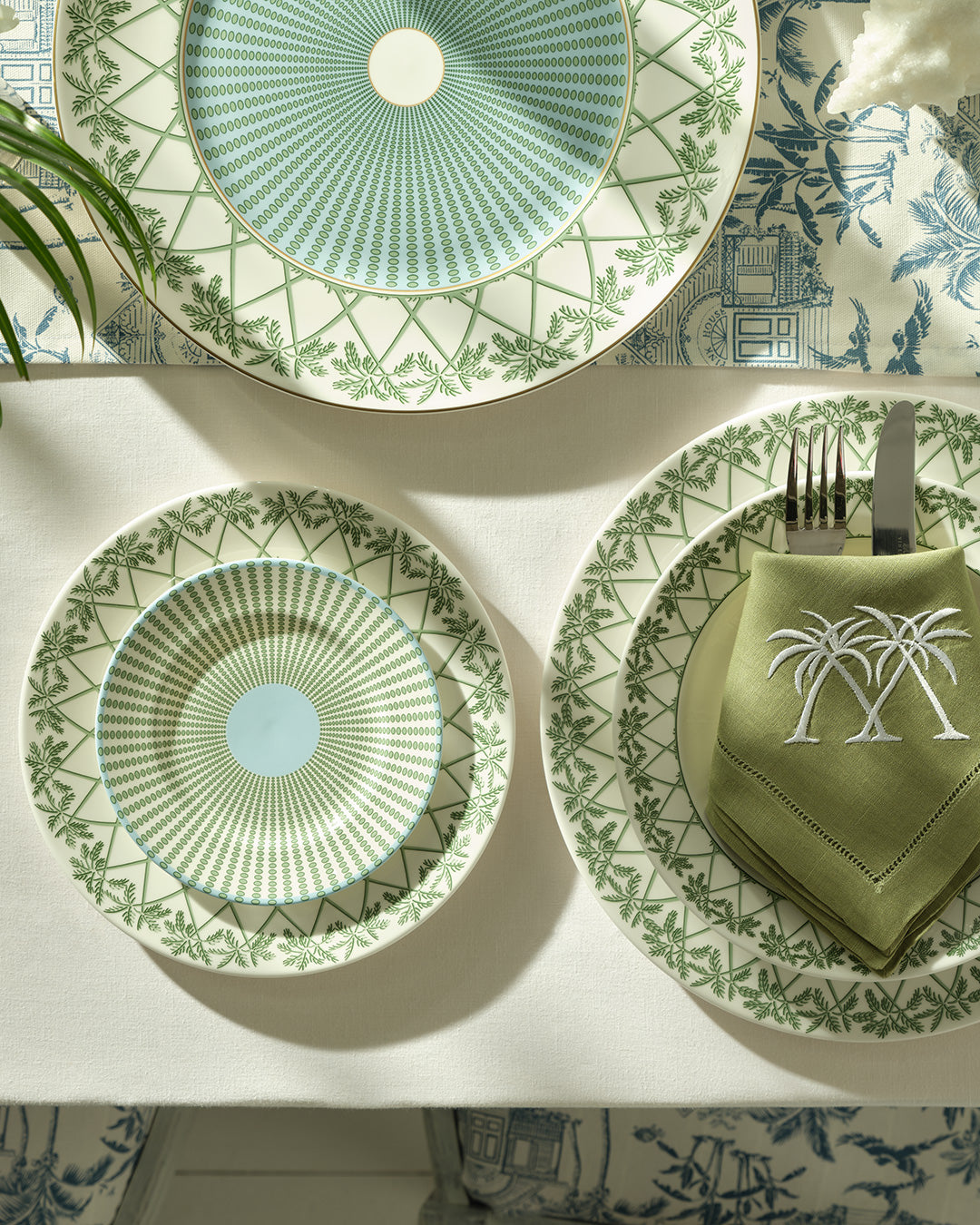 Elegant fine bone china charger and side plates stacked on salad plate in Palms Sage Green design by Pink House Mustique.