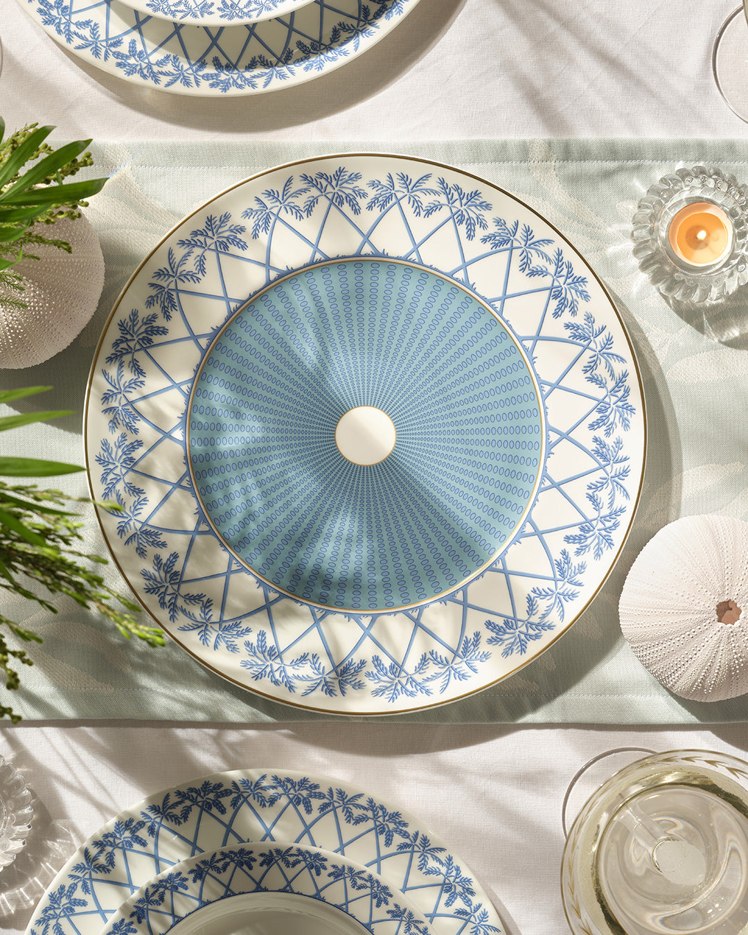 Elegant fine bone china charger plate in Palms Azure blue with gold rim, luxury island-inspired tableware by Pink House Mustique