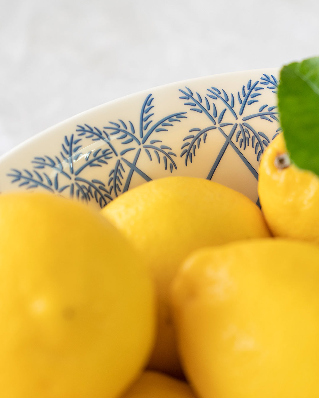 Crafted by artisans in Stoke-on-Trent UK fine bone china large serving bowl rim detail in blue Palms design by Lotty B