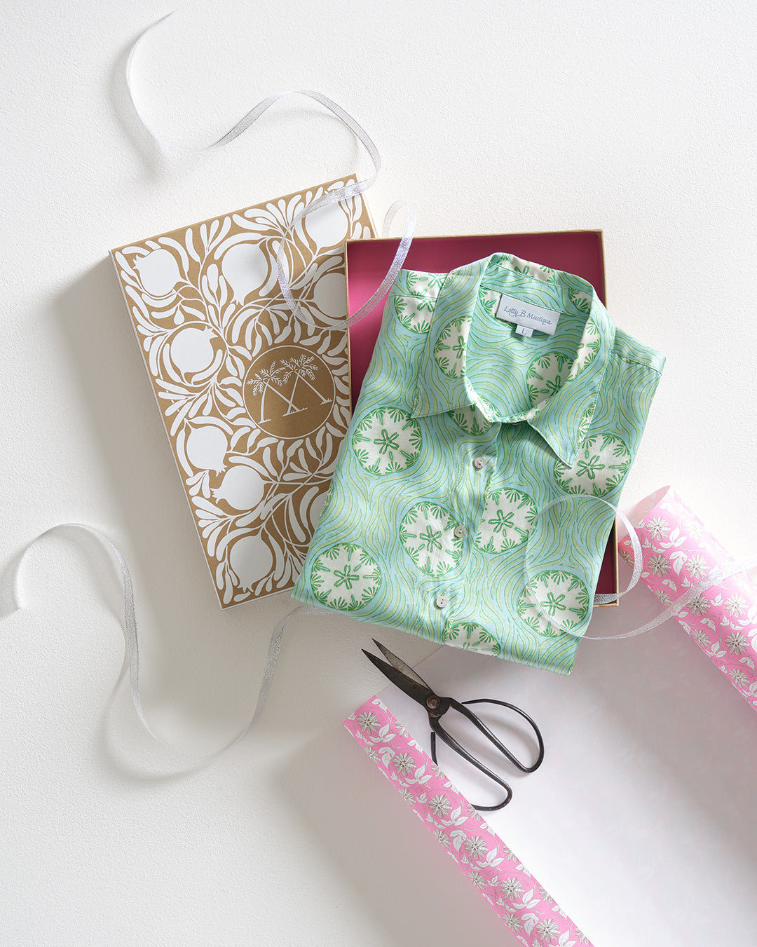 Luxury gift wrapping service with Lotty B Sand Dollar green silk shirt and Pink House Mustique signature packaging.