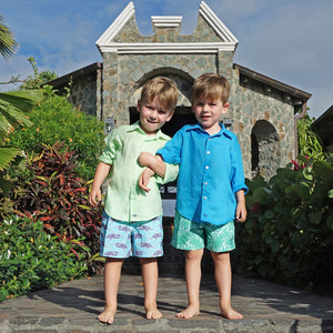 Kids tropical holiday styles in sustainable turquoise blue swim shorts with Egret bird print