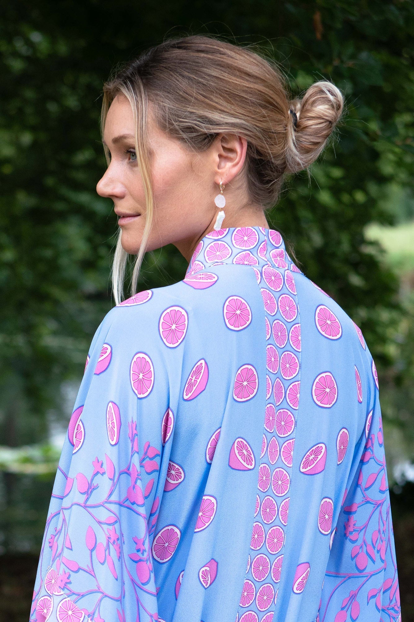 Detailed back view of Lotty B Jade Poncho in Lime Tree Blue/Pink – tropical silk kaftan with citrus print and fine tailoring, ideal for beach-to-bar style.
