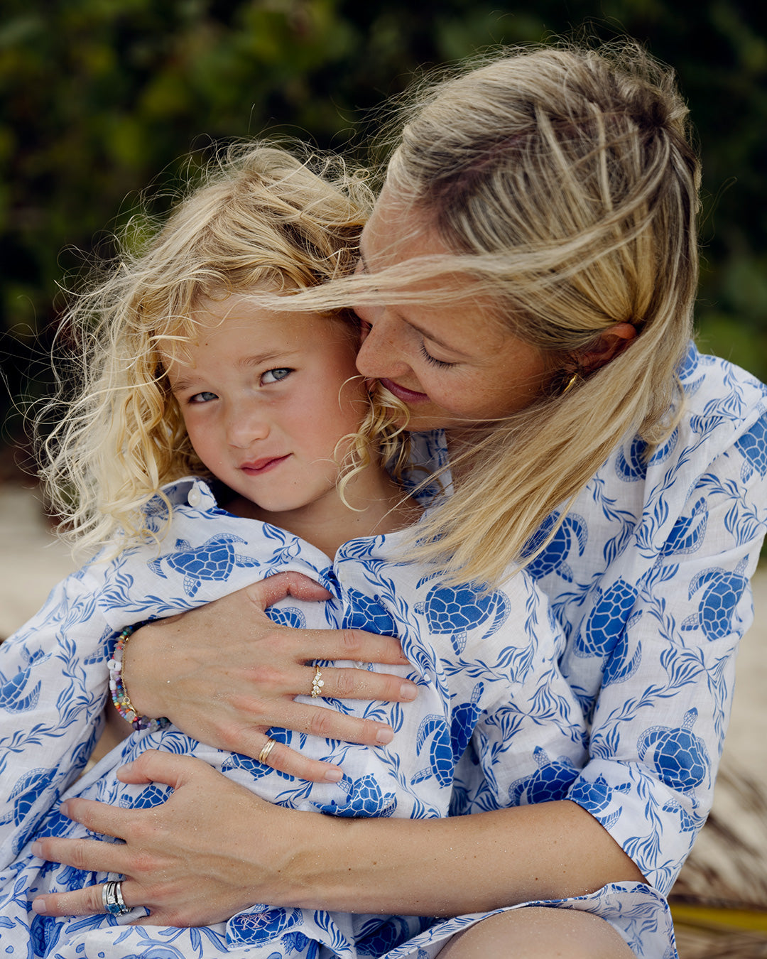 mother and daughter in matching linen holiday shirt