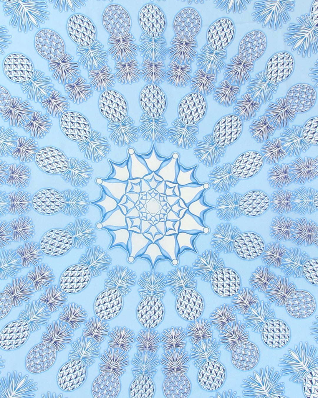 Close-up detail of Lotty B Pineapple Blue silk sarong print, tropical luxury beachwear from Mustique.