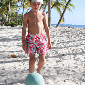 Boys fun beach swim shorts in turquoise blue and coral red Striped Shell print by designer Lotty B