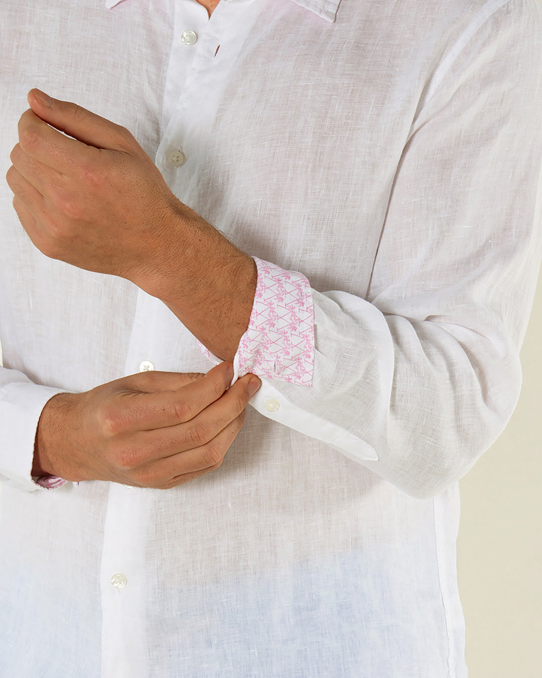 Close-up of Pink House Mustique Classic White Linen Shirt – showcasing pink contrast print lining on cuffs and premium lightweight linen fabric for refined tropical dressing.