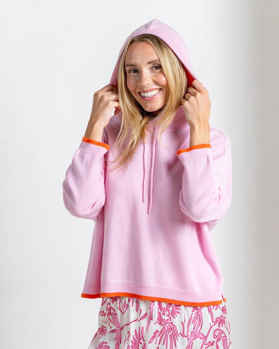 Pale pink cashmere hoodie collab Darlin London x Pink House Mustique with orange trim