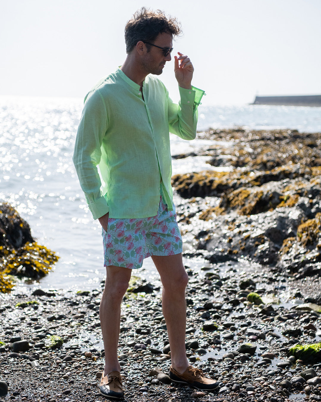Mens pistachio green linen collarless shirt relaxed beach style with monkey print swim shorts, lightweight summer outfit