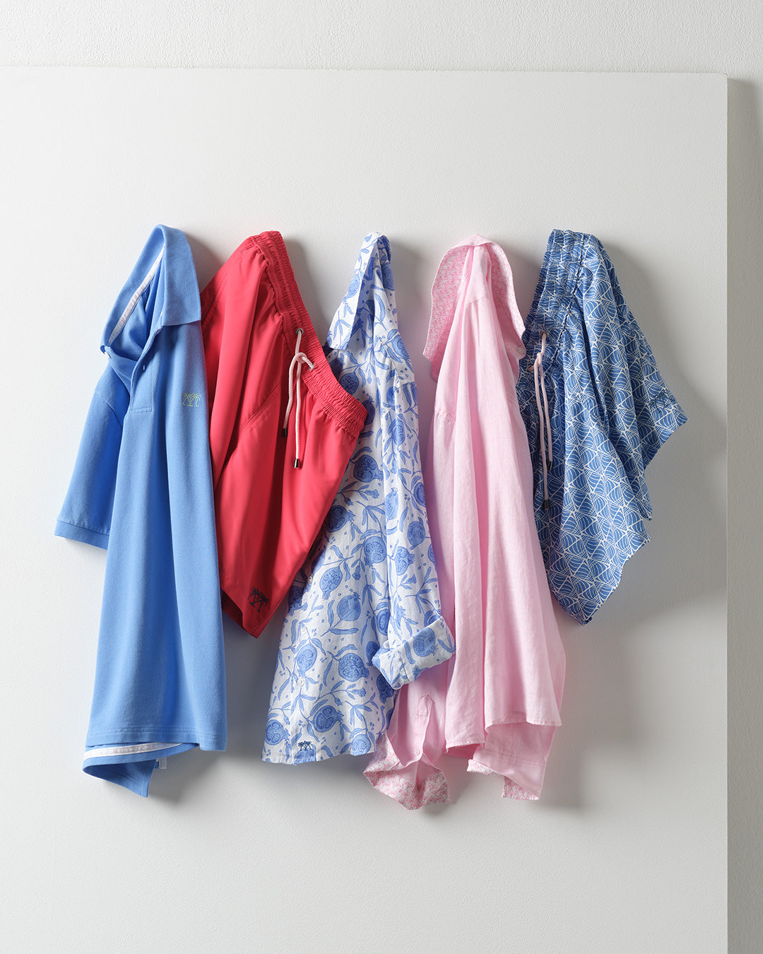 Pink House Mustique men's resortwear featuring cotton polo, linen shirts and swim shorts in coordinated summer colours