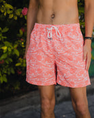 man in pink swim shorts