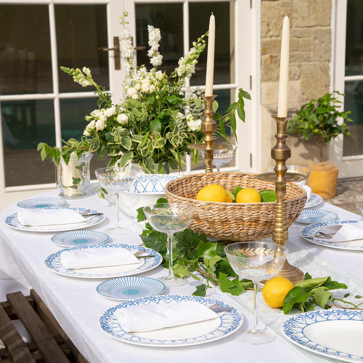 Outdoor dining style in fine bone china set of plates and bowls in Palms blue design by Lotty B Mustique