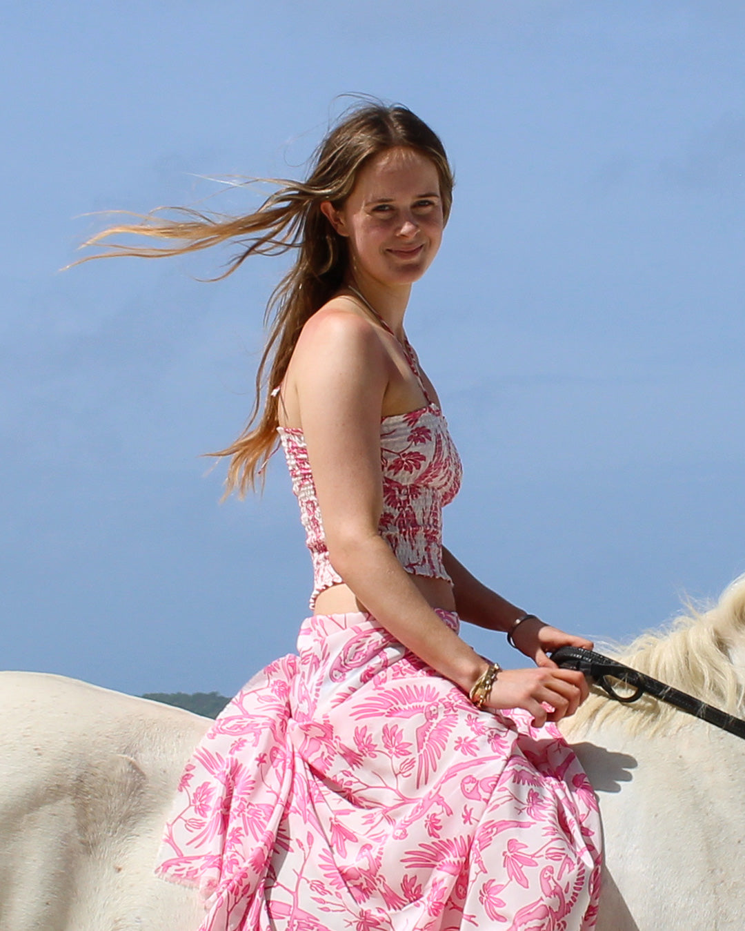 Crepe silk Parrot Pink bandeau top and matching sarong on horse by sea in Mustique – island style resortwear