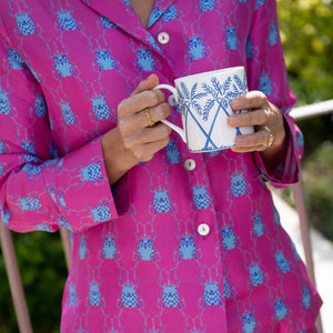 A fine bone china mug in blue Palms design and a pair of pink silk pajamas, beautiful gifts from Pink House