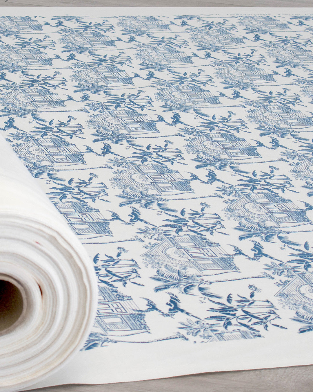 Pink House Toile blue 100% cotton furnishing fabric featuring Caribbean houses, palms and tropical island motifs