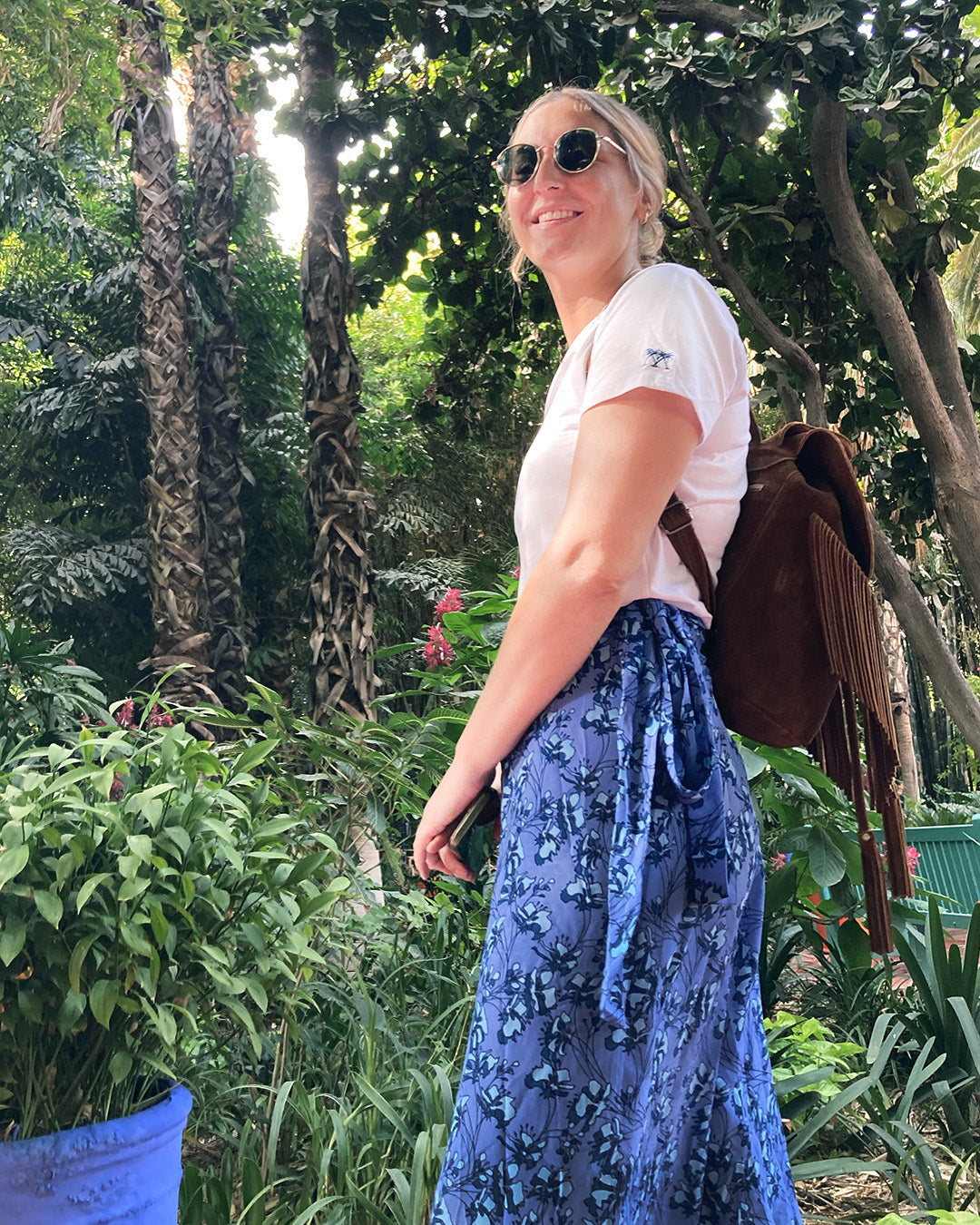 Abi wearing a Pink House women’s plain white T-shirt styled for relaxed everyday wear in a tropical garden setting