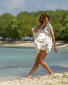 Beach holiday cover up pure silk white kaftan by designer Lotty B styled by Kim on Lagoon Bay, Mustique Island