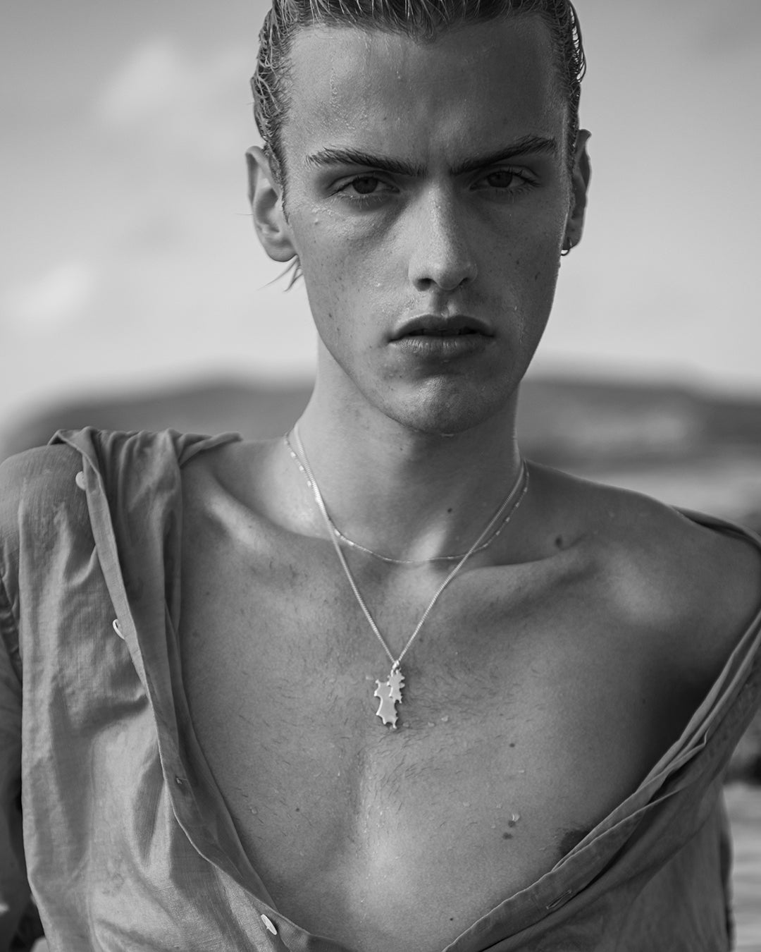 Stacked sterling silver Mustique island pendant necklaces worn at the beach hallmarked jewellery Made in England