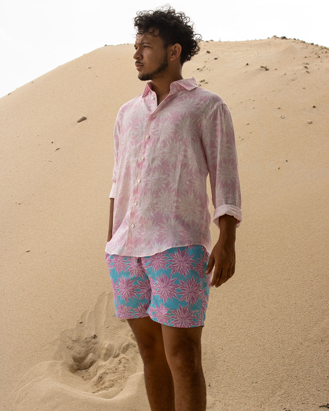 Men’s Agave pink linen shirt and turquoise pink swim trunks, relaxed island style from Pink House Mustique Resort 2026.