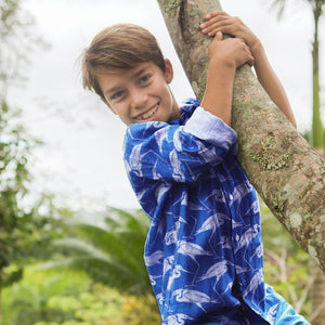 Tree climbing in fun linen holiday shirt with egret print by Lotty B Mustique