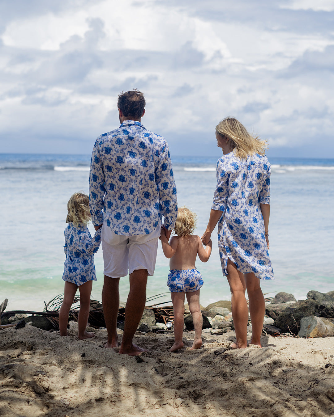 family in matching holiday linen clothes