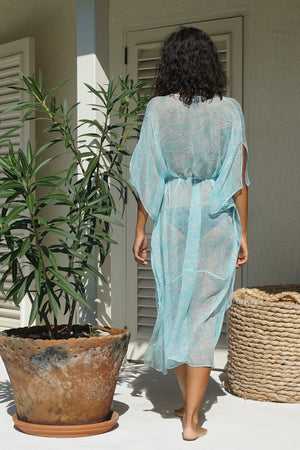 translucent chiffon silk kaftan featuring a simple V neckline with tassel ties and a fluttering square handkerchief hem falling to mid-calf