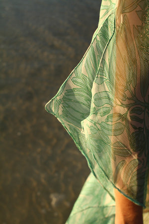 Designer silk holiday styles in sage green and white Protea design by Lotty B Mustique