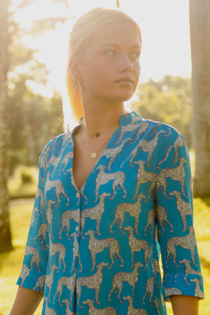 Designer travel fashion short flared dress in pure silk Lurcher green blue print designer Lotty B Mustique