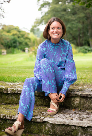 Party outfit fit & flare silk trousers in Protea violet & turquoise print by designer Lotty B