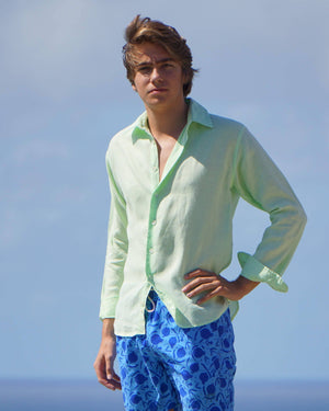 Mens summer linen shirt bright green worn with blue swim shorts in pomegranate print by designer Lotty B for Pink House Mustique 