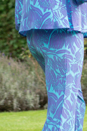 Wedding guest outfit fit & flare silk trousers in Protea violet & turquoise print by designer Lotty B
