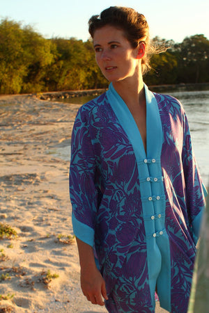 Luxury fashion silk poncho in violet & turquoise Prote print designed by Lotty B Mustique