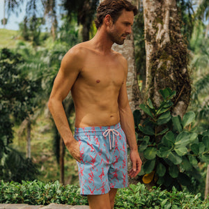 Tropical style swim shorts, pink Fruit Punch print on blue